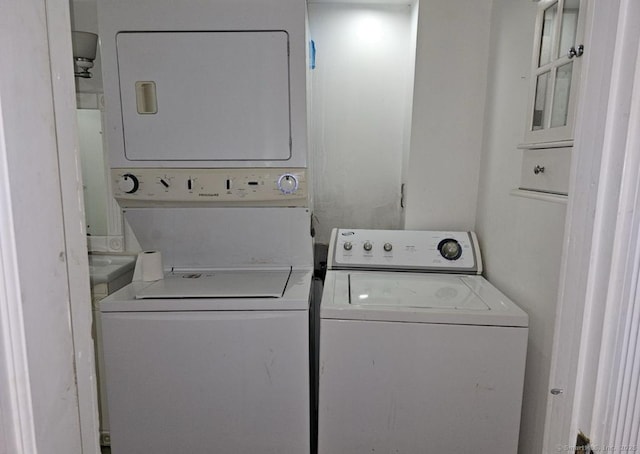 1067 Hartford Tpke, Waterford, CT 06385 - laundry room featuring stacked washer / drying machine and laundry area