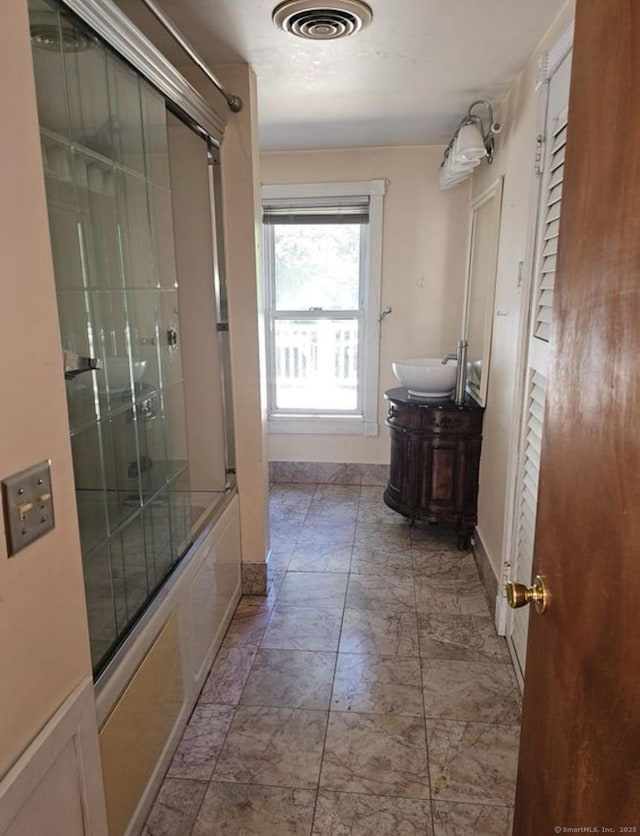 1067 Hartford Tpke, Waterford, CT 06385 - bathroom with vanity, baseboards, combined bath / shower with glass door, and visible vents
