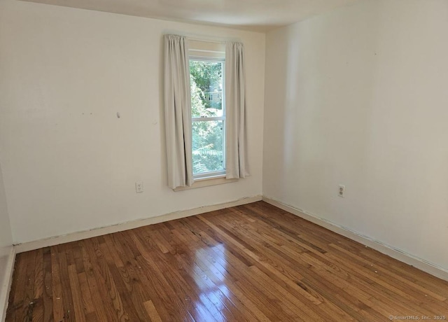 1067 Hartford Tpke, Waterford, CT 06385 - empty room with baseboards and wood finished floors