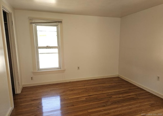 1067 Hartford Tpke, Waterford, CT 06385 - unfurnished room featuring baseboards, a wealth of natural light, and dark wood-type flooring