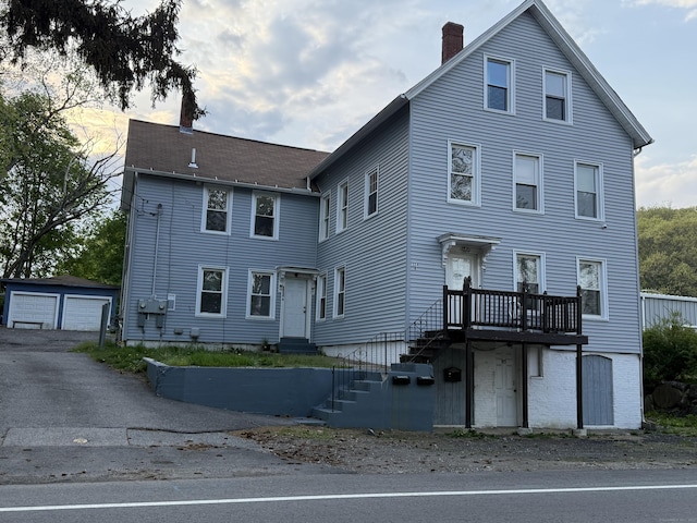 324 Norwich Ave, Norwich, CT 06380 - view of front facade featuring a detached garage, an outbuilding, and a chimney