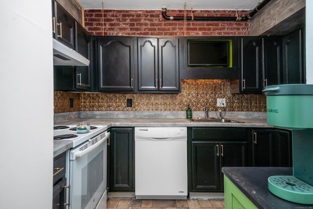 kitchen with a sink, backsplash, under cabinet range hood, and white appliances