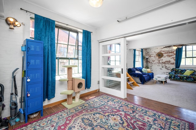 doorway with wood-type flooring and a ceiling fan