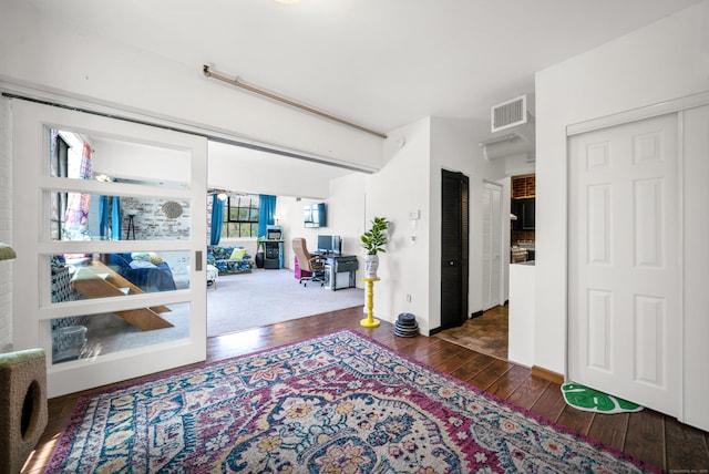 interior space featuring wood-type flooring and visible vents
