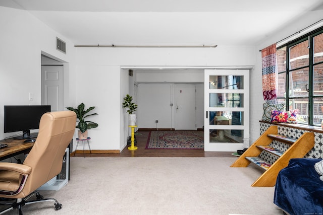 home office featuring carpet flooring, wood finished floors, and visible vents