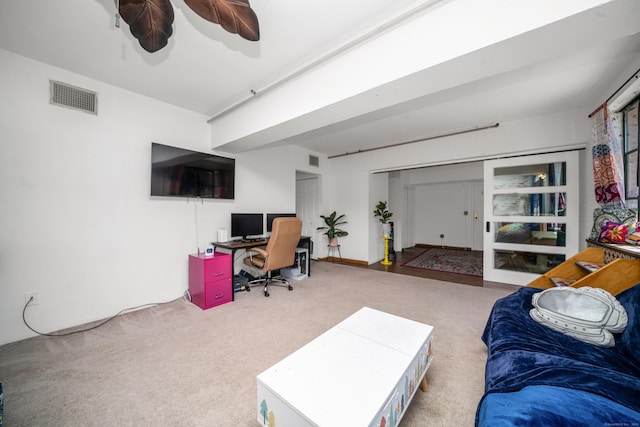 office area featuring carpet floors, a ceiling fan, and visible vents