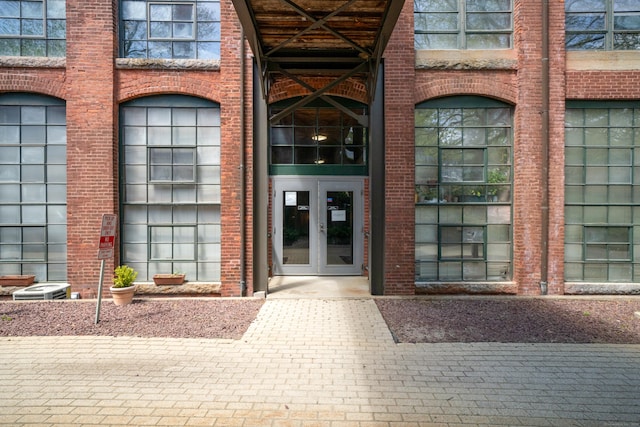 property entrance with french doors and brick siding