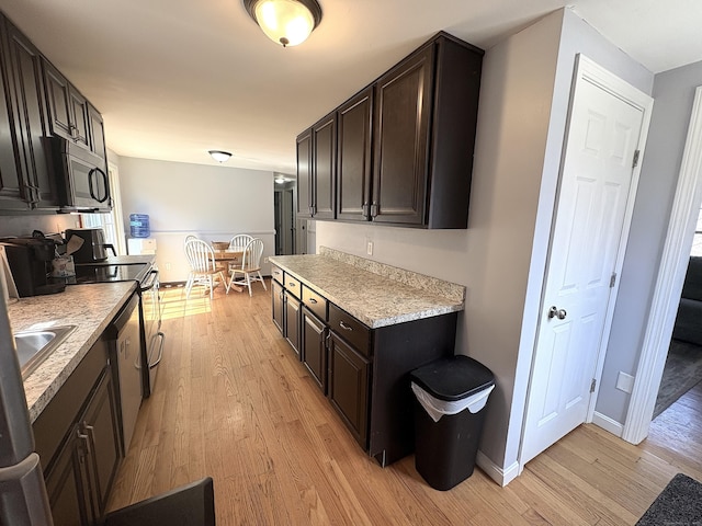 161 Old New London Rd, Salem, CT 06420 - kitchen featuring dark brown cabinetry, appliances with stainless steel finishes, light wood-style floors, light countertops, and baseboards