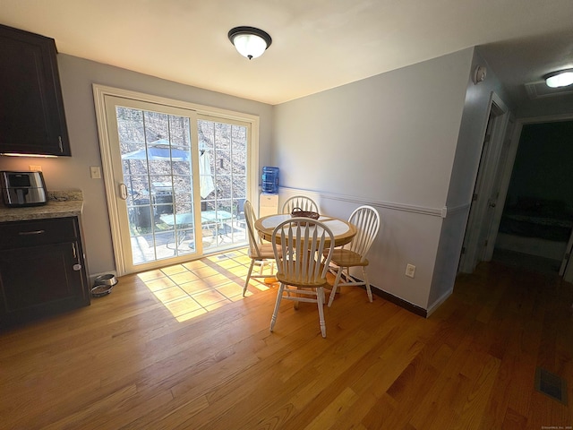 161 Old New London Rd, Salem, CT 06420 - dining area featuring visible vents, wainscoting, and light wood-style flooring