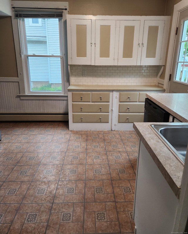kitchen featuring white cabinets, tasteful backsplash, glass insert cabinets, and dishwasher