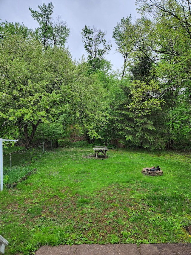 view of yard featuring fence and a fire pit