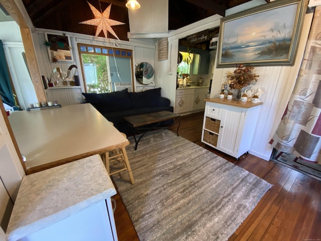 living room with wooden walls and dark wood-style floors