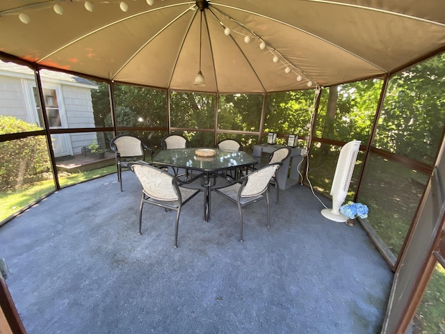 sunroom with outdoor dining area