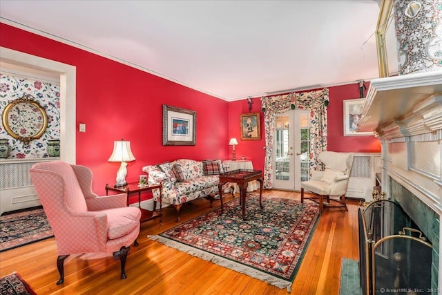 399 N Benson Rd, Fairfield, CT 06824 - living area with french doors, wood-type flooring, a fireplace, and ornamental molding
