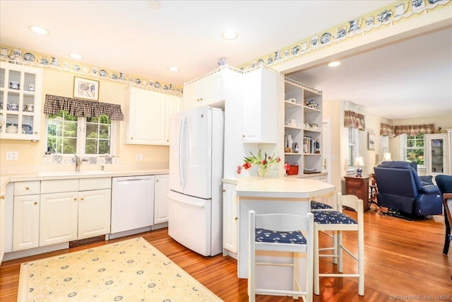 399 N Benson Rd, Fairfield, CT 06824 - kitchen with white appliances, a sink, open floor plan, white cabinetry, and recessed lighting