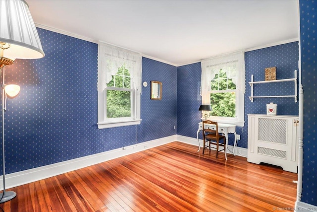399 N Benson Rd, Fairfield, CT 06824 - empty room featuring hardwood / wood-style floors, crown molding, baseboards, radiator heating unit, and wallpapered walls