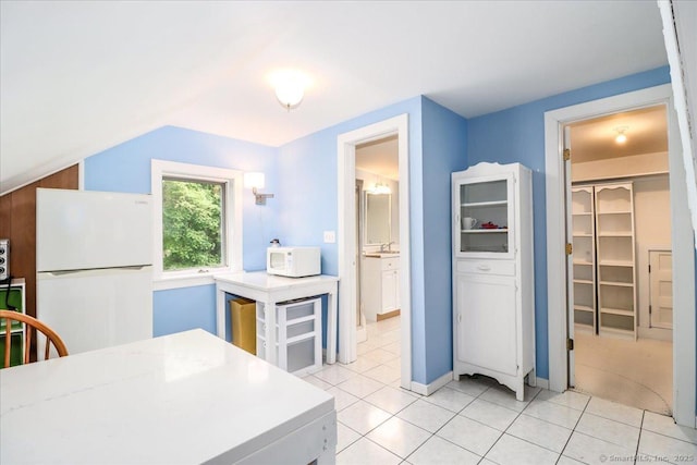 399 N Benson Rd, Fairfield, CT 06824 - kitchen with white appliances, light tile patterned floors, light countertops, and vaulted ceiling