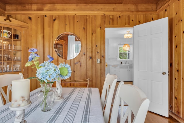 dining area featuring wooden walls