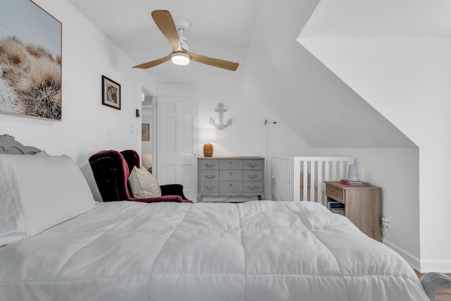 bedroom featuring vaulted ceiling, baseboards, and a ceiling fan