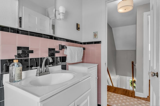 bathroom with vanity, tile walls, and wainscoting