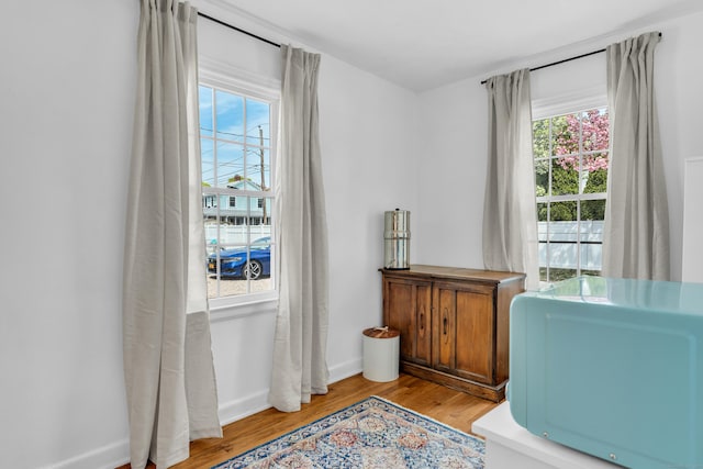 sitting room featuring baseboards and light wood-style flooring