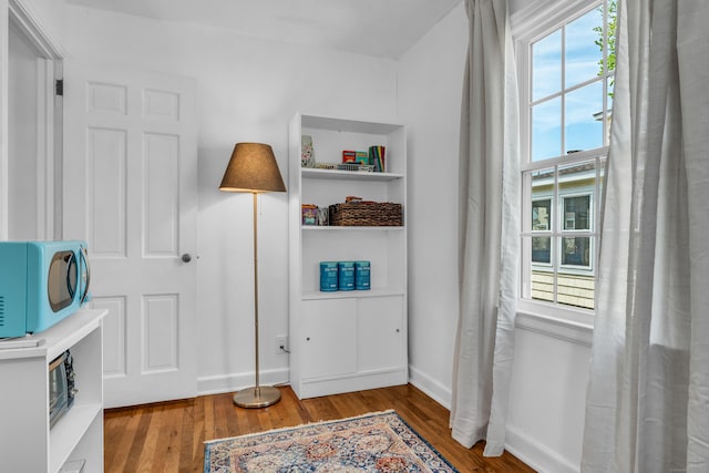 interior space featuring baseboards and wood finished floors