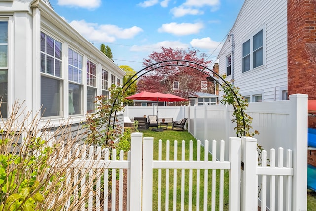 view of side of home featuring a yard, fence private yard, and outdoor lounge area