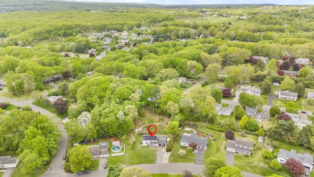 aerial perspective of suburban area featuring a forest
