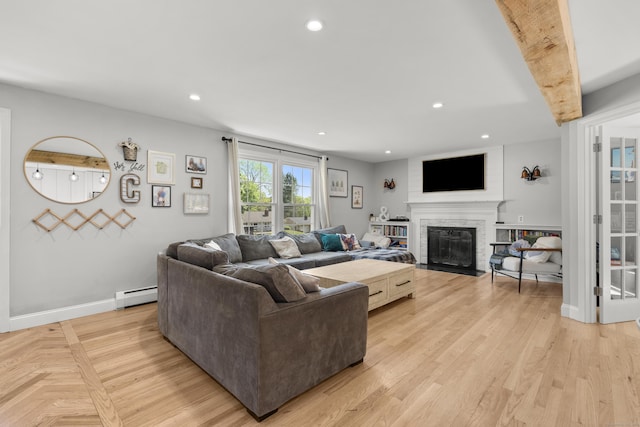 living room with a baseboard heating unit, a fireplace with flush hearth, recessed lighting, baseboards, and light wood-style flooring