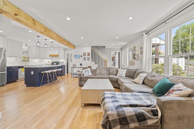 living room with recessed lighting, stairs, light wood-style floors, and beamed ceiling