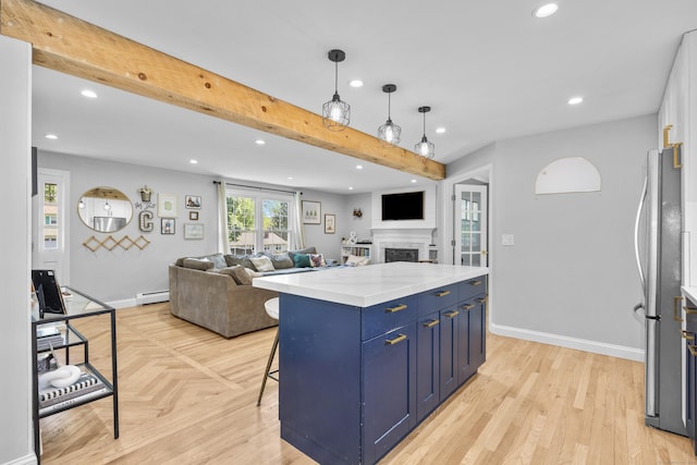 kitchen with baseboard heating, blue cabinetry, recessed lighting, a fireplace, and freestanding refrigerator