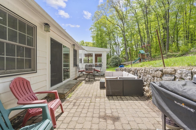 view of patio featuring an outdoor hangout area, outdoor dining space, and a playground