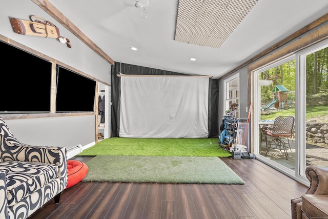 playroom with a baseboard heating unit, wood finished floors, lofted ceiling, golf simulator, and recessed lighting