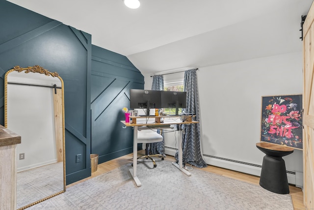 office area with a barn door, lofted ceiling, wood finished floors, and a baseboard radiator