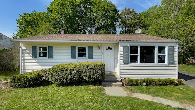 76 Midway Dr, Bethel, CT 06801 - view of front of house featuring a chimney and a front yard