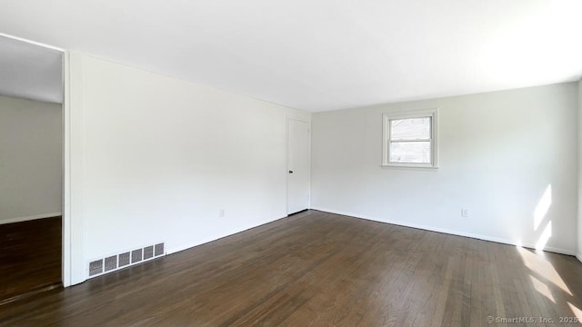76 Midway Dr, Bethel, CT 06801 - empty room featuring visible vents, dark wood-style flooring, and baseboards