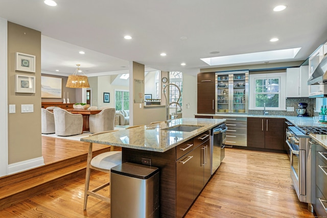 33 Bickford Ln, New Canaan, CT 06840 - kitchen featuring a sink, appliances with stainless steel finishes, light wood-style floors, a skylight, and recessed lighting