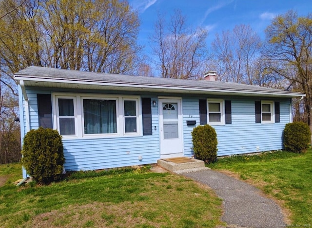 74 Midway Dr, Bethel, CT 06801 - view of front of property with a chimney and a front lawn