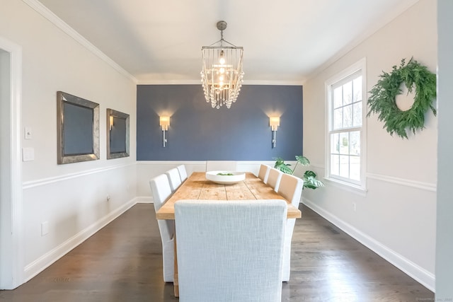 dining space with crown molding, baseboards, dark wood-type flooring, and a chandelier