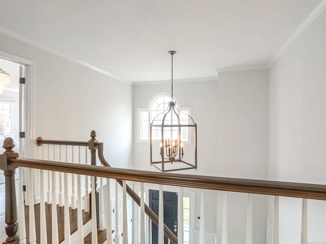 interior space with an inviting chandelier and ornamental molding