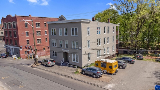 view of building exterior featuring uncovered parking