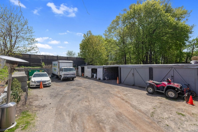view of car parking featuring fence
