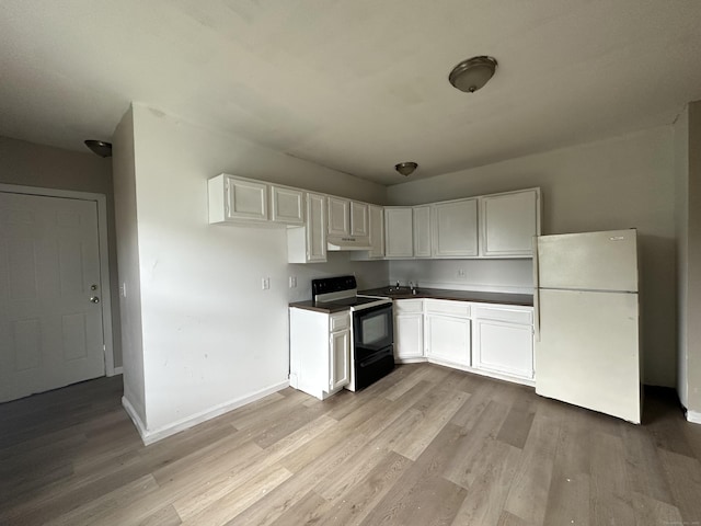 kitchen with freestanding refrigerator, black range with electric stovetop, and light wood-style flooring