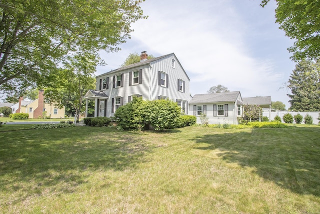 62 Lynde St, Old Saybrook, CT 06475 - colonial-style house featuring a chimney and a front lawn