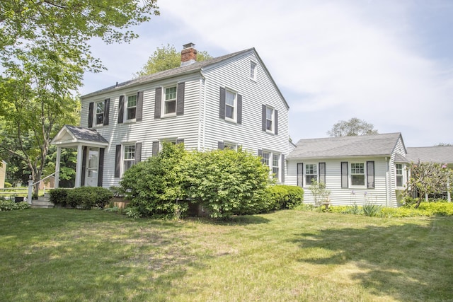 62 Lynde St, Old Saybrook, CT 06475 - view of front facade featuring a chimney and a front yard