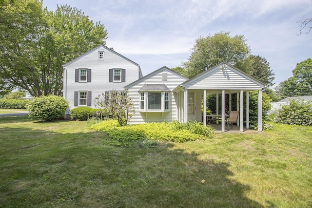 62 Lynde St, Old Saybrook, CT 06475 - back of house with a lawn