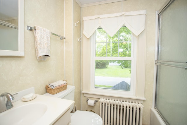 62 Lynde St, Old Saybrook, CT 06475 - bathroom with radiator heating unit, toilet, bath / shower combo with glass door, and vanity