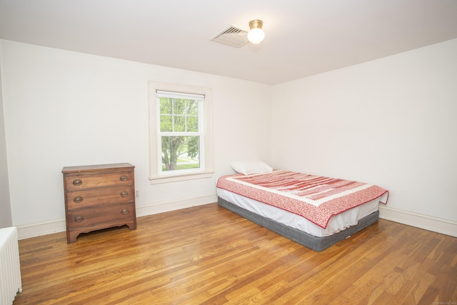 62 Lynde St, Old Saybrook, CT 06475 - bedroom with radiator heating unit, wood finished floors, and baseboards