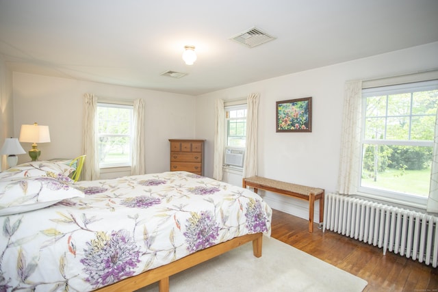 62 Lynde St, Old Saybrook, CT 06475 - bedroom featuring radiator heating unit, multiple windows, and wood finished floors