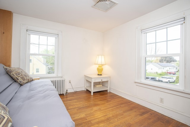 62 Lynde St, Old Saybrook, CT 06475 - bedroom featuring radiator heating unit, light wood-type flooring, and baseboards